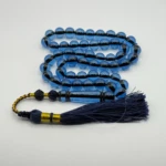 مسبحة باكالايت أزرق شفاف – 51 حبّة – 10 مم مع طربوش كحلي و ذهبي